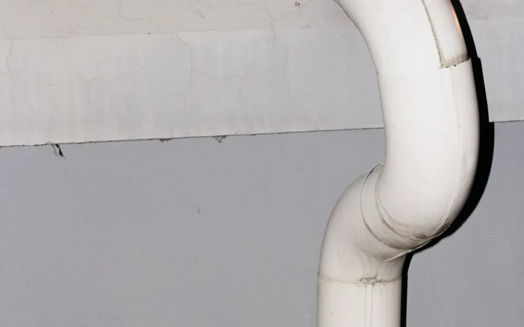 White downspout running down a wall in Hallsville, MO