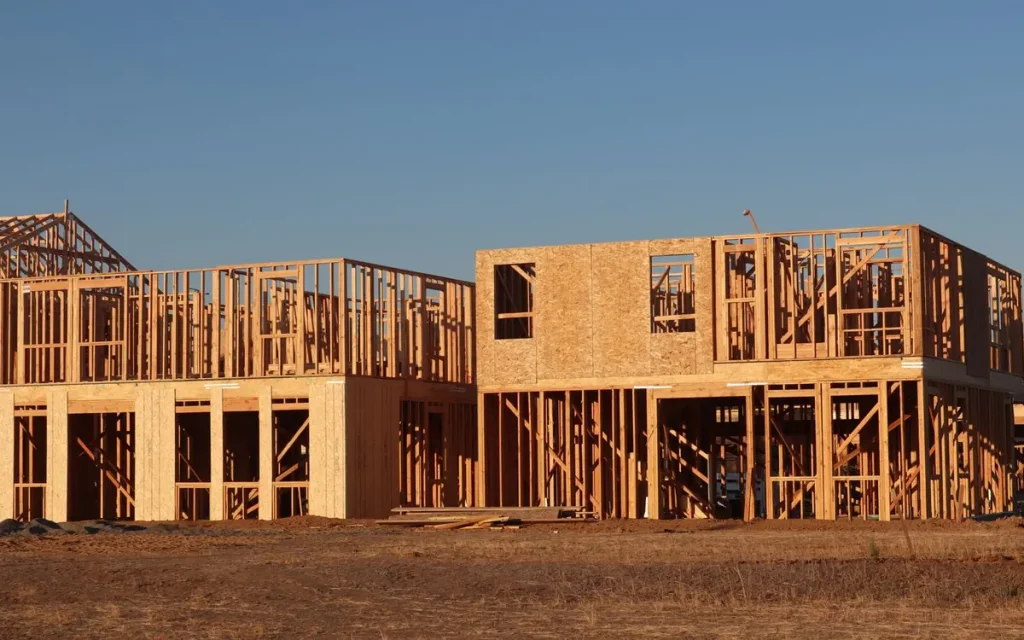 House framing on a concrete foundation at dusk, foundation repair crew in Columbia, MO